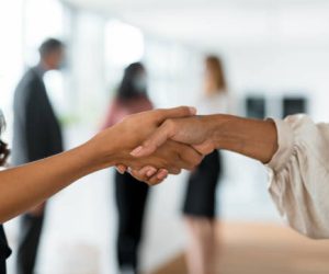 Close Up Of Two Women Shaking Hands In The Office
